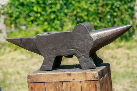 Iron anvil on wooden tableの写真素材