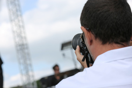 Male photographer clicking pictures on camera