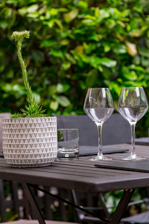 close-up of the cutlery of a gourmet restaurant table with greenery in the backgroundの写真素材