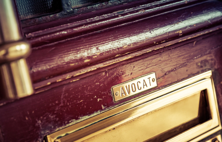 closeup on Old letterbox in the door with lawyer name ("Avocat" in french). Concept of lawyer services.の写真素材