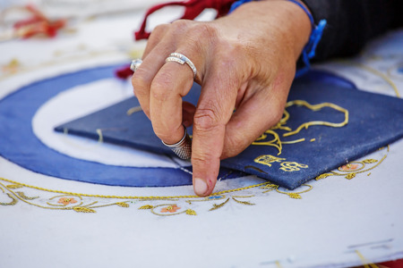 Brouage, France - June 25, 2016 : Closeup of woman artist hand manufacturing and working with stain glass during day at Brouage, France.のeditorial素材