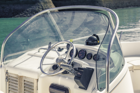 Isle of Re, France - August 22, 2016: Instrument panel and steering wheel of a motorboat cockpit in Ile de Re, France, an island near La Rochelle.のeditorial素材