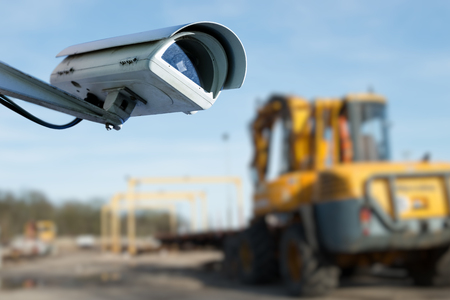 security CCTV camera or surveillance system with industrial site on blurry backgroundの写真素材