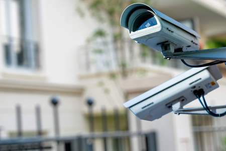 Focus on security CCTV camera or surveillance system with private builiding on blurry backgroundの写真素材