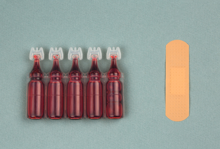 colored disinfectant and adhesive plaster blue white background.The concept of First Aid Equipment.の写真素材