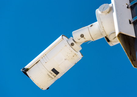 Close-up of modern CCTV camera on the wall of an industrial building