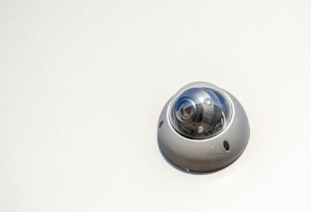 Close-up of modern CCTV camera on the wall of an industrial building