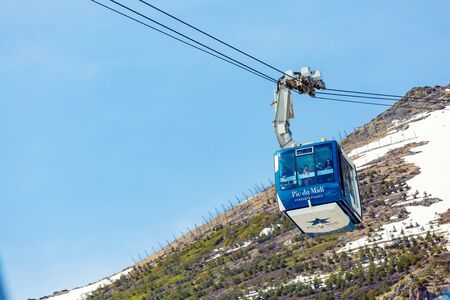 La Mongie, France - March 23, 2019:The cable car from La Mongie with tourists inside up to the Pic du Midi at an altitude of 2900 metersのeditorial素材