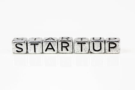 Startup concept with cubic metal letters on white background