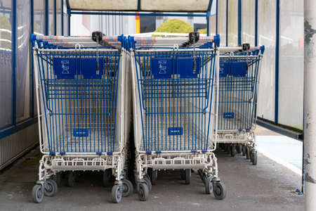 Cognac, France - February 16, 2020:LeaderPrice Supermarket shopping trolleys aligned and stored in an empty supermarket with no customersのeditorial素材