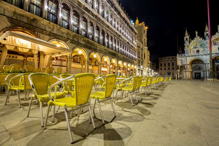 Venice, Italy - March 19, 2015:Night view of the Piazza San Marco showing a multitude of empty chairs belonging to a renowned bar. There are no more tourists on the square that has become desertedのeditorial素材