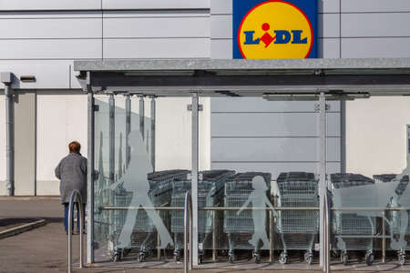 Cognac, France - February 21, 2020:Lidl supermarket shopping trolleys on a parking lot deserted by...