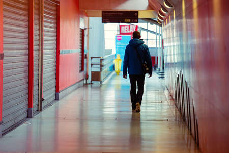 Paris, France - April 15, 2016:Lonely man walking in a shopping alley at St Lazarre train station with the shops closed on each sideのeditorial素材