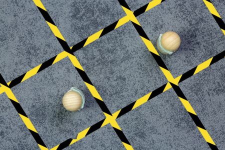 concept of marking on the ground and signage, for physical or social distance in the street or in...
