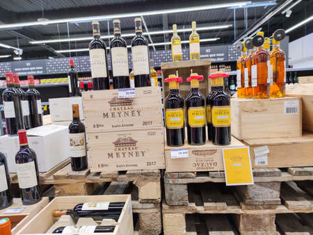 Surgeres, France - October 17, 2020: Row of Classified Growths bottles French wines display for sell in the supermarket shelvesのeditorial素材
