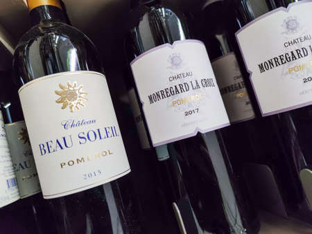 Builboreau, France - October 14, 2020: Row of Pomerol Bottles, Classified Growths bottles French wines display for sell in the supermarket shelvesのeditorial素材
