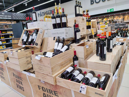 Surgeres, France - October 17, 2020: Row of Classified Growths bottles French wines display for sell...