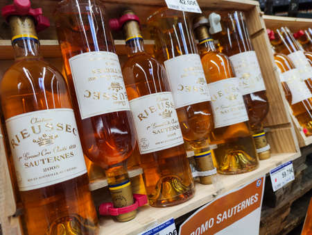 Surgeres, France - October 17, 2020: Row of Sauternes Bottles, French sweet wine display for sell in the supermarket shelvesのeditorial素材