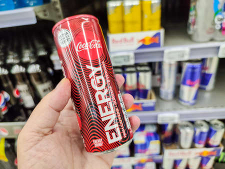 Puilboreau, France - October 14, 2020: Closeup of Man hand buying Can of Coca cola Energy Drink...