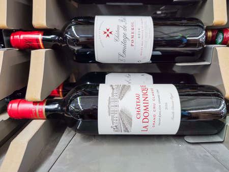 Builboreau, France - October 14, 2020: Closeup of Man hand buying a Saint-Emilion Classified Growth bottle, a great French bordeaux wine in supermarketのeditorial素材