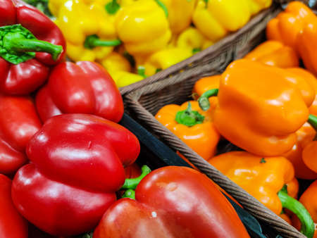 Selected focus on Group of various bell peppers sold on a market