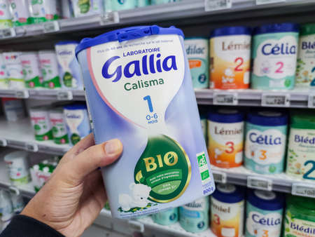 Puilboreau, France - October 14, 2020: A consumer chooses a box of Gallia brand baby milk from the baby food section of a supermarketのeditorial素材