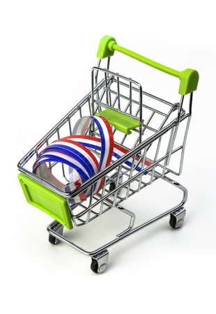 closeup on supermarket shopping cart isolated with a French tricolor ribbon, symbol of purchase of products made in Franceの写真素材