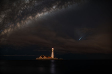 A lighthouse casting beams of swirling nebulasの素材