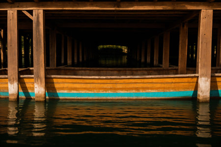 Detail of a weathered wooden boat on a lakeの素材