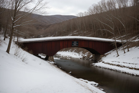 A snow-covered bridge over a frozen riverの素材
