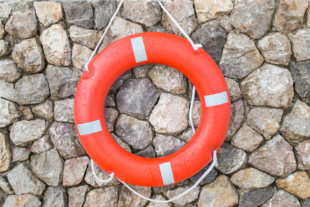 lifebuoy on stone wall background