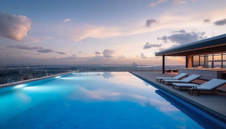 Swimming pool in luxury hotel with view of the city at sunsetの写真素材