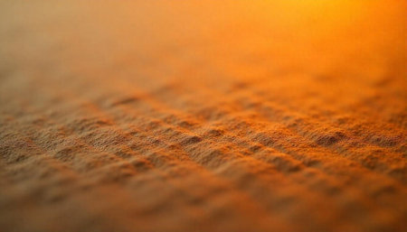 Textured amber surface with soft orange glowing background lightingの写真素材