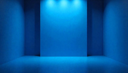 Empty blue room illuminated by spotlights on top wallの写真素材