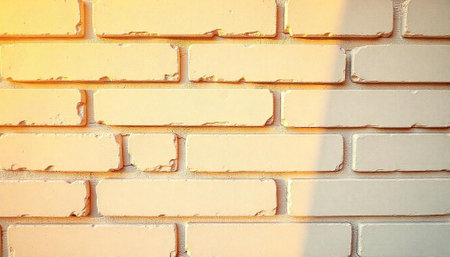 Cream brick wall texture with soft sunlight and shadows