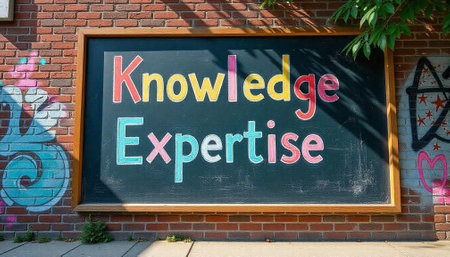 Knowledge and expertise chalkboard sign against a brick wallの写真素材