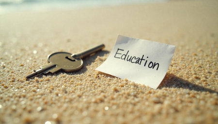 Key to education concept on a bright sandy beach