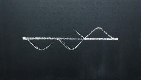 White chalk drawing of a wave on black chalkboardの写真素材