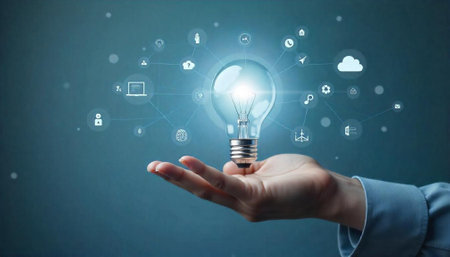 Hand holding light bulb surrounded by technology and innovation icons