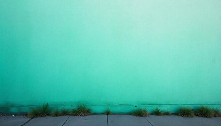 Minimalist Turquoise Wall with Grass Along Gray Sidewalk