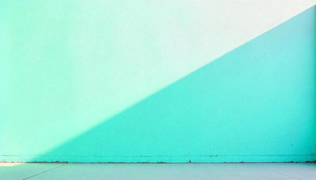 Minimalist turquoise wall with diagonal light shadow patternの写真素材