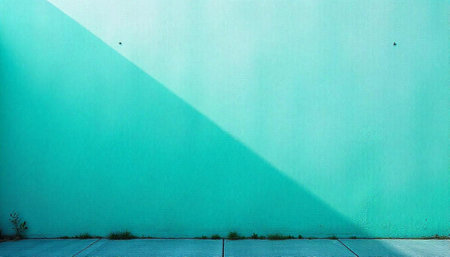 Teal wall with strong shadow and minimal foreground elementsの写真素材