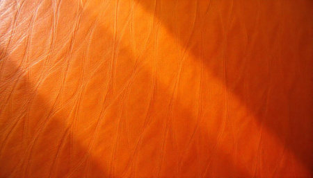 Vibrant orange leather texture with subtle light variations across