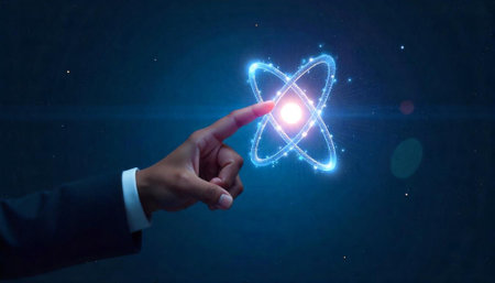 Person interacts with glowing atom in a dark spaceの写真素材