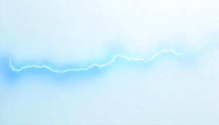 Lightning strike over pale blue gradient background imageの写真素材