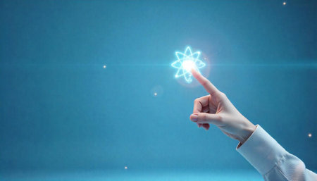 Finger touching a glowing atom symbol on blue backdropの写真素材