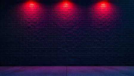 Dramatic brick wall illuminated by striking red spotlight accentsの写真素材