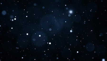 Floating white particles or dots over a dark blue background