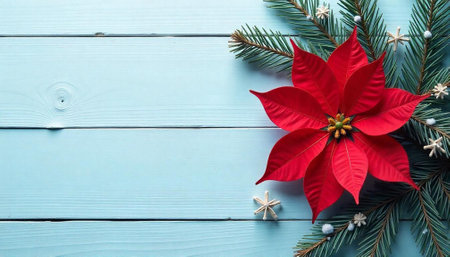Festive holiday composition featuring poinsettia, pine and wooden surfaceの写真素材
