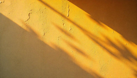 Golden wall surface with striking light and shadow patternsの写真素材